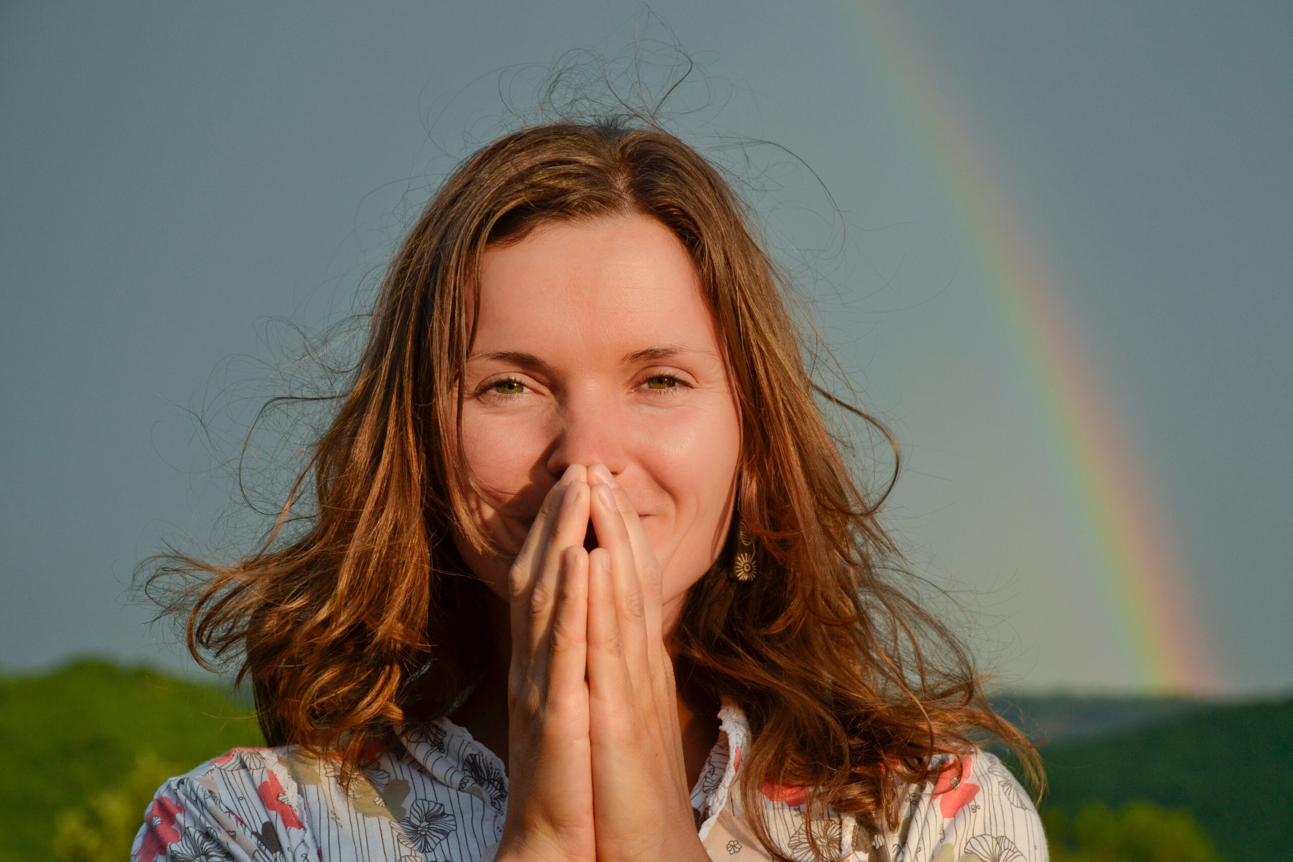 Beautiful young woman looking thanking sun has returned