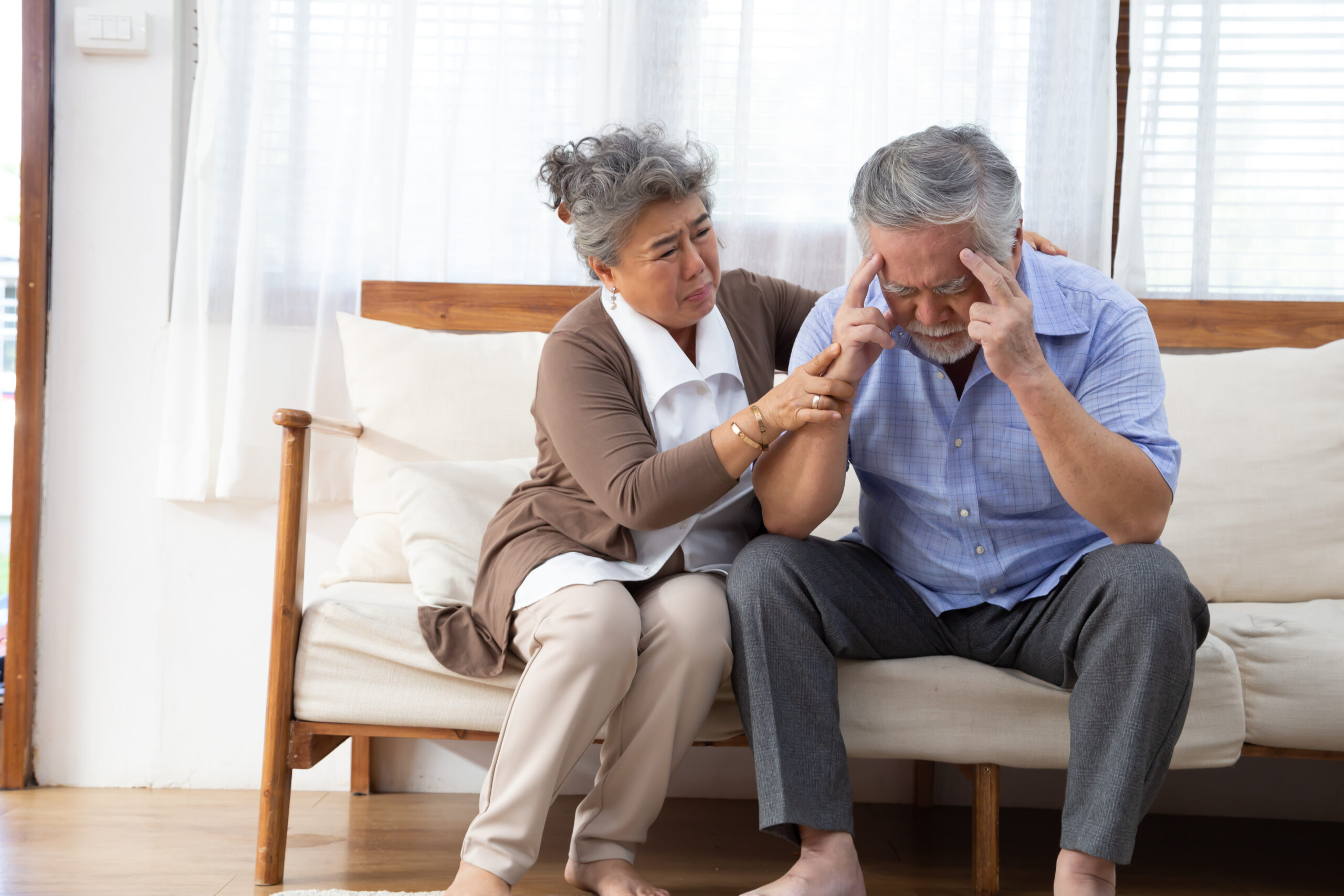 Asian senior retired couple holding hands and take care together at home, Alzheimer disease or suffering with dementia concept